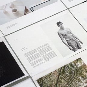 a collection of design documents. in the center is a documnet featuring illegible text and a photo of a person